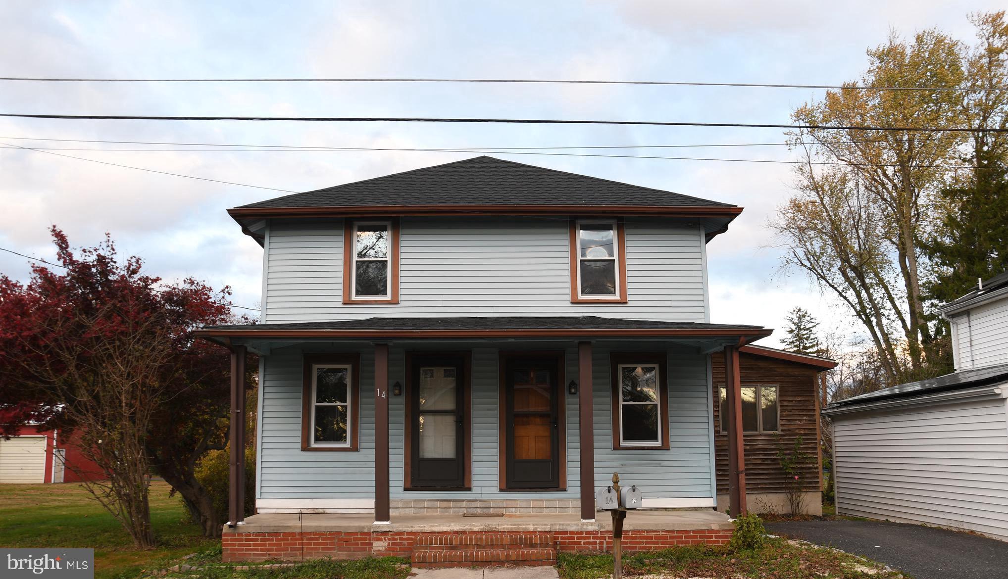 a house with lots of trees in the background