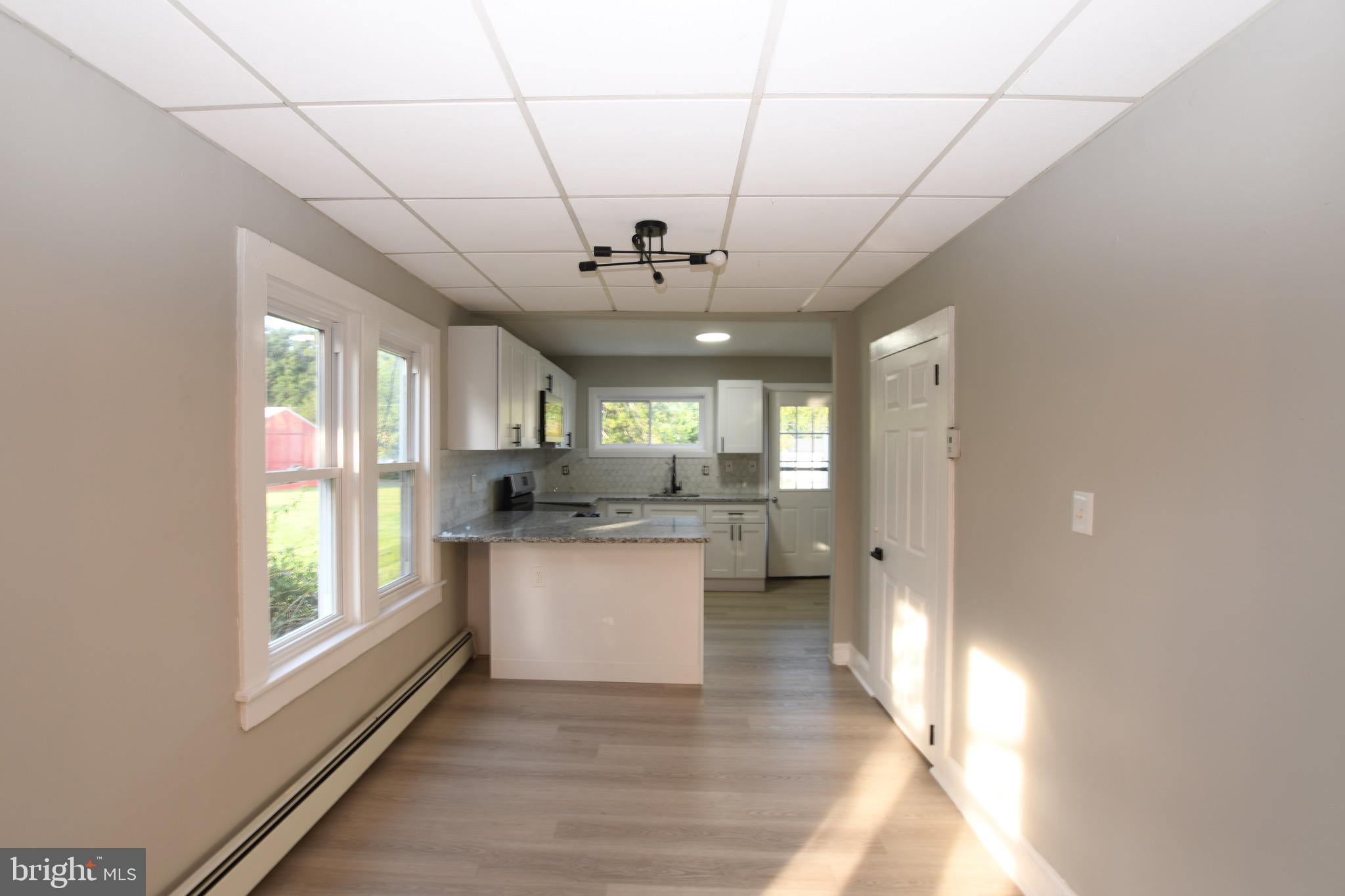 14 Delaware Avenue Salem, NJ 08079 - Photo 6 of 15 a open kitchen with stainless steel appliances granite countertop a stove a sink dishwasher and a refrigerator with wooden floor