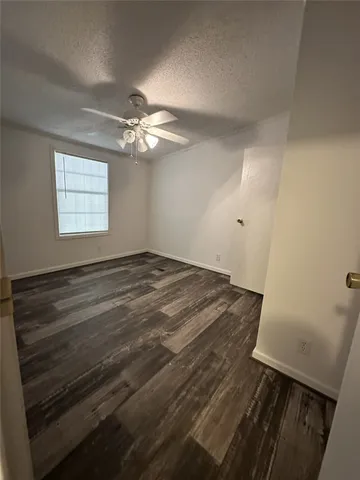 a view of room with window and ceiling fan