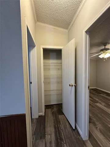a view of a hallway with wooden floor and staircase