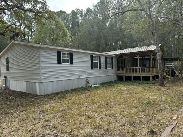 a view of a house with a yard and sitting area