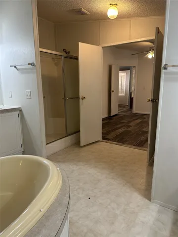a spacious bathroom with a bathtub and shower