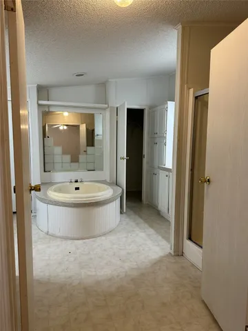 a view of bathroom with bathtub and shower