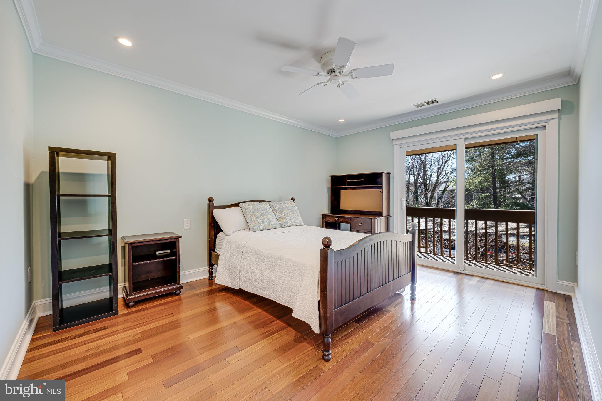 11222 Lagoon Lane Reston, VA 20191 - Photo 13 of 20 a bedroom with a bed and wooden floor