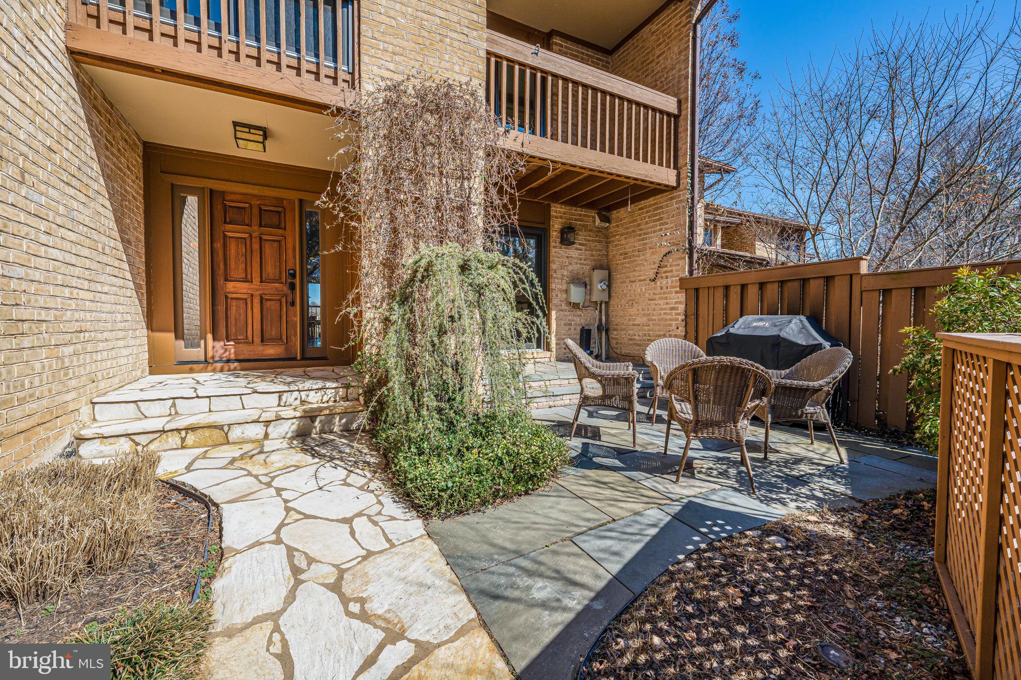 11222 Lagoon Lane Reston, VA 20191 - Photo 2 of 20 a front view of a house with garden and seating area