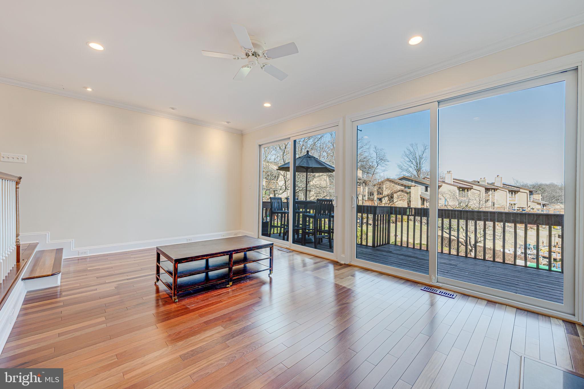 11222 Lagoon Lane Reston, VA 20191 - Photo 5 of 20 an empty room with wooden floor and windows