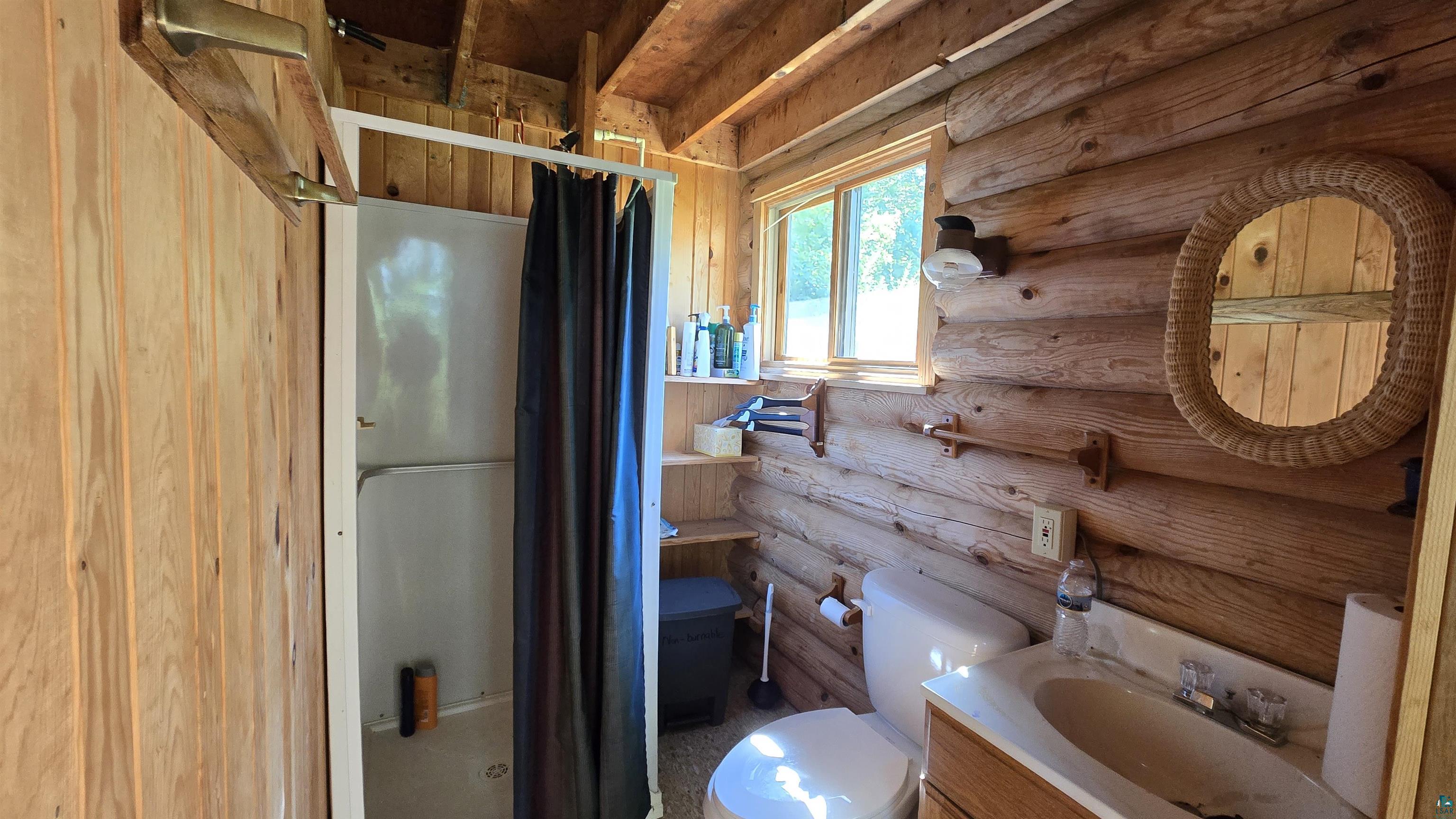Tbd33 Tbd33 Donovan Point Orr, MN 55771 - Photo 12 of 50 Bathroom featuring a stall shower, vanity, and rustic walls