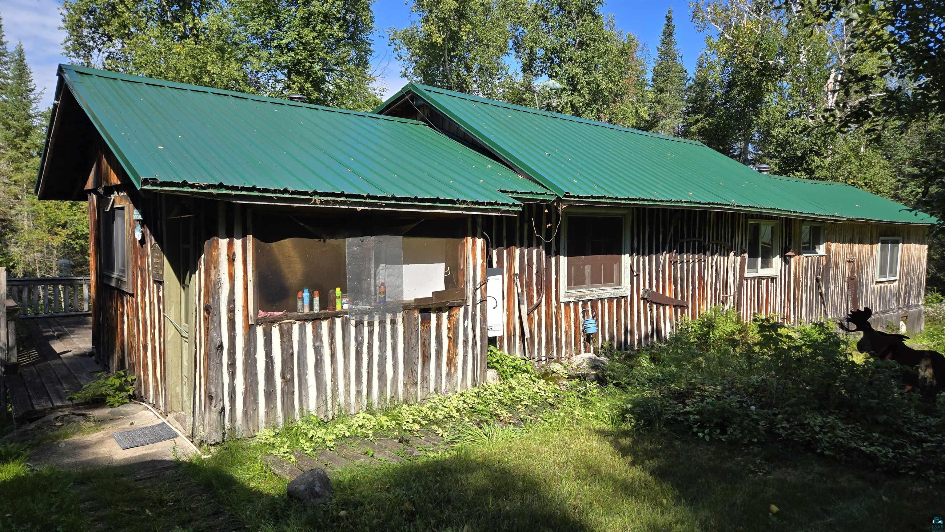 Tbd33 Tbd33 Donovan Point Orr, MN 55771 - Photo 15 of 50 View of side of property with board and batten siding, a metal roof, and a wooden deck