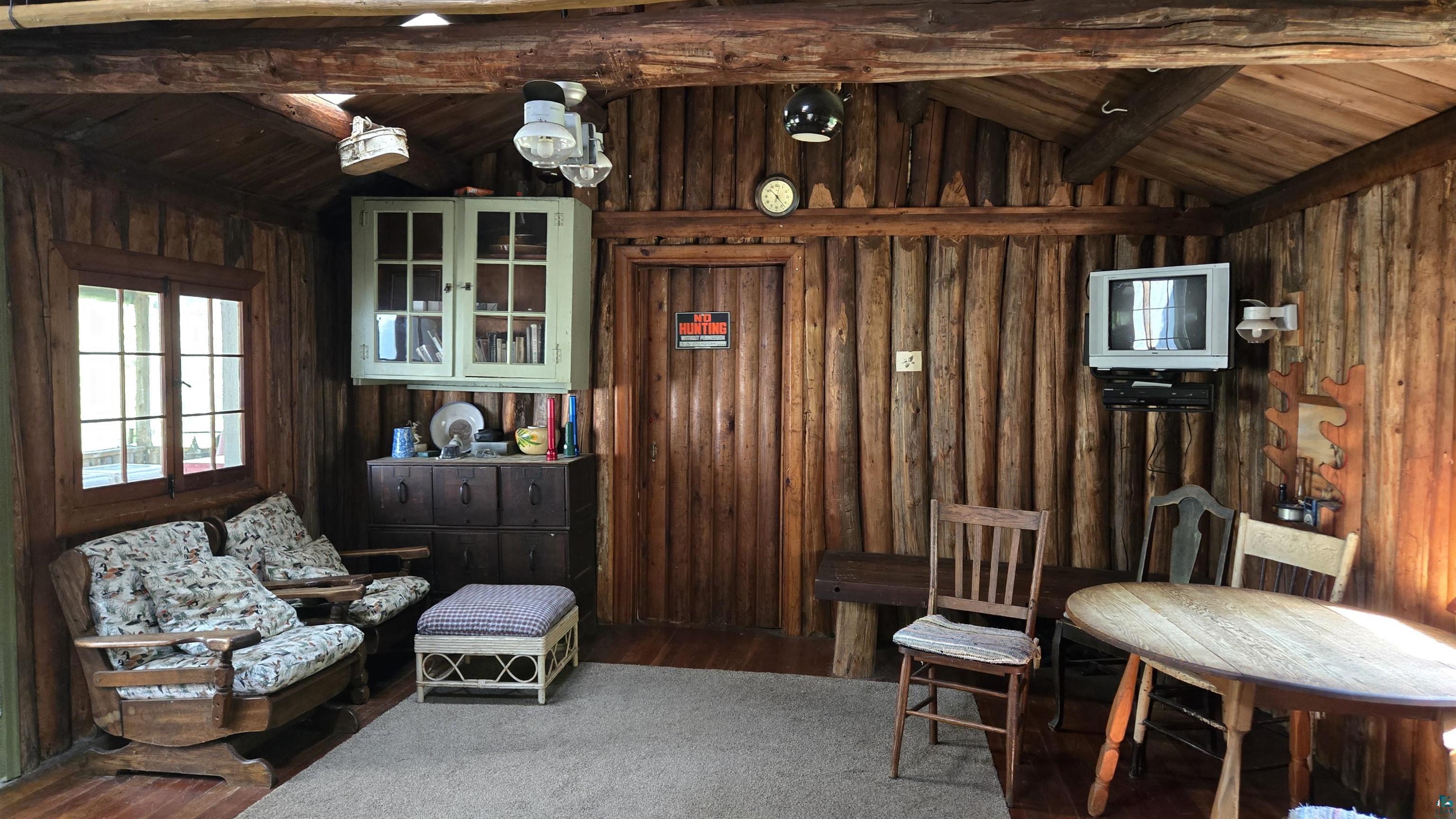 Tbd33 Tbd33 Donovan Point Orr, MN 55771 - Photo 24 of 50 Living area with a wooden ceiling with exposed beams, wood finished floors, and wooden walls