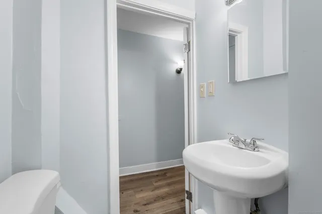 a bathroom with a sink a toilet and mirror