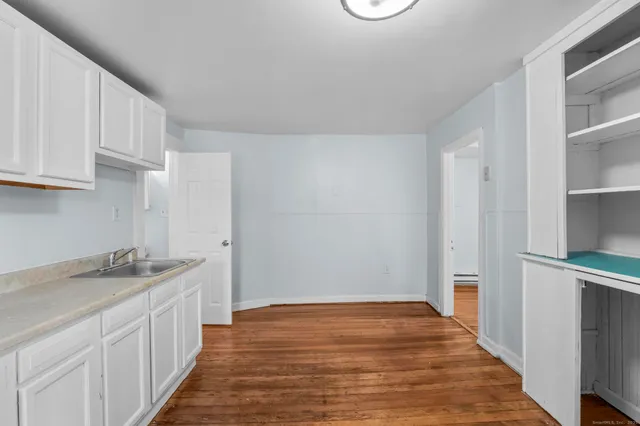 a kitchen with a sink stove and cabinets