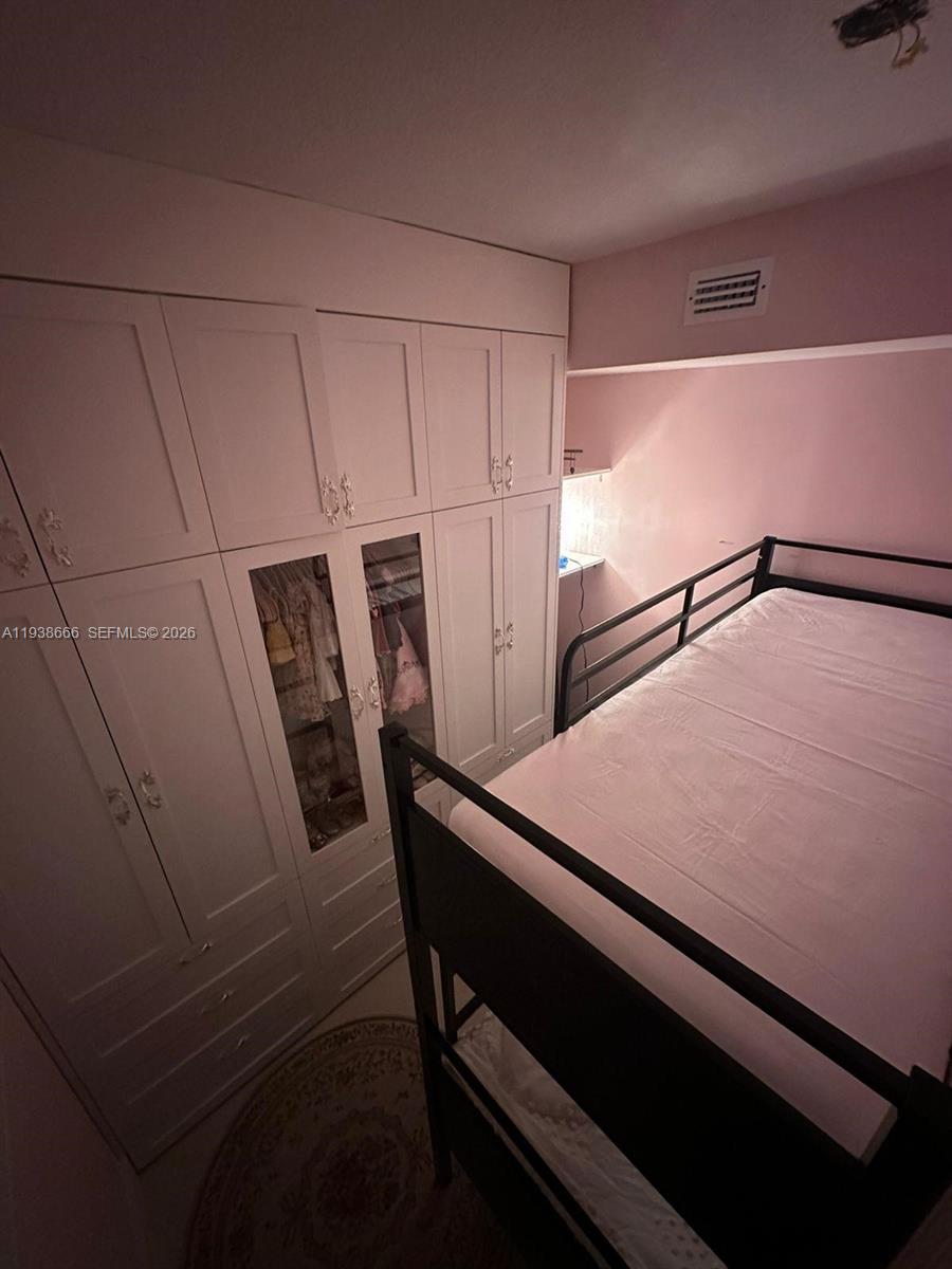 60 Southwest 13th Street, Unit 2422 Miami, FL 33130 - Photo 18 of 33 a room with a table chairs and refrigerator