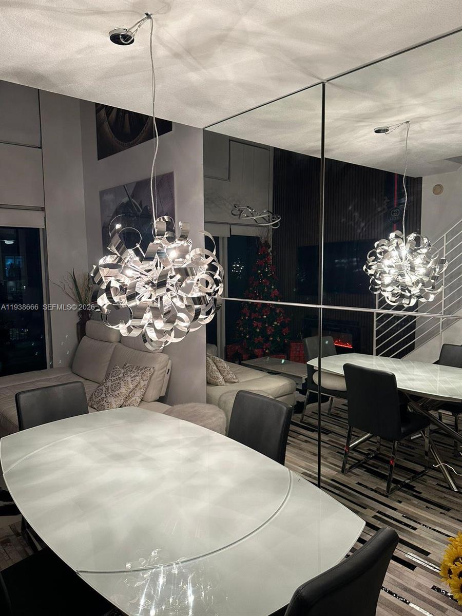 60 Southwest 13th Street, Unit 2422 Miami, FL 33130 - Photo 23 of 33 a living room with furniture a chandelier and a fireplace