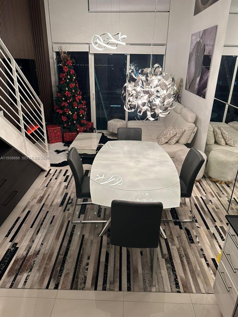 60 Southwest 13th Street, Unit 2422 Miami, FL 33130 - Photo 26 of 33 a view of a dining room with furniture and chandelier