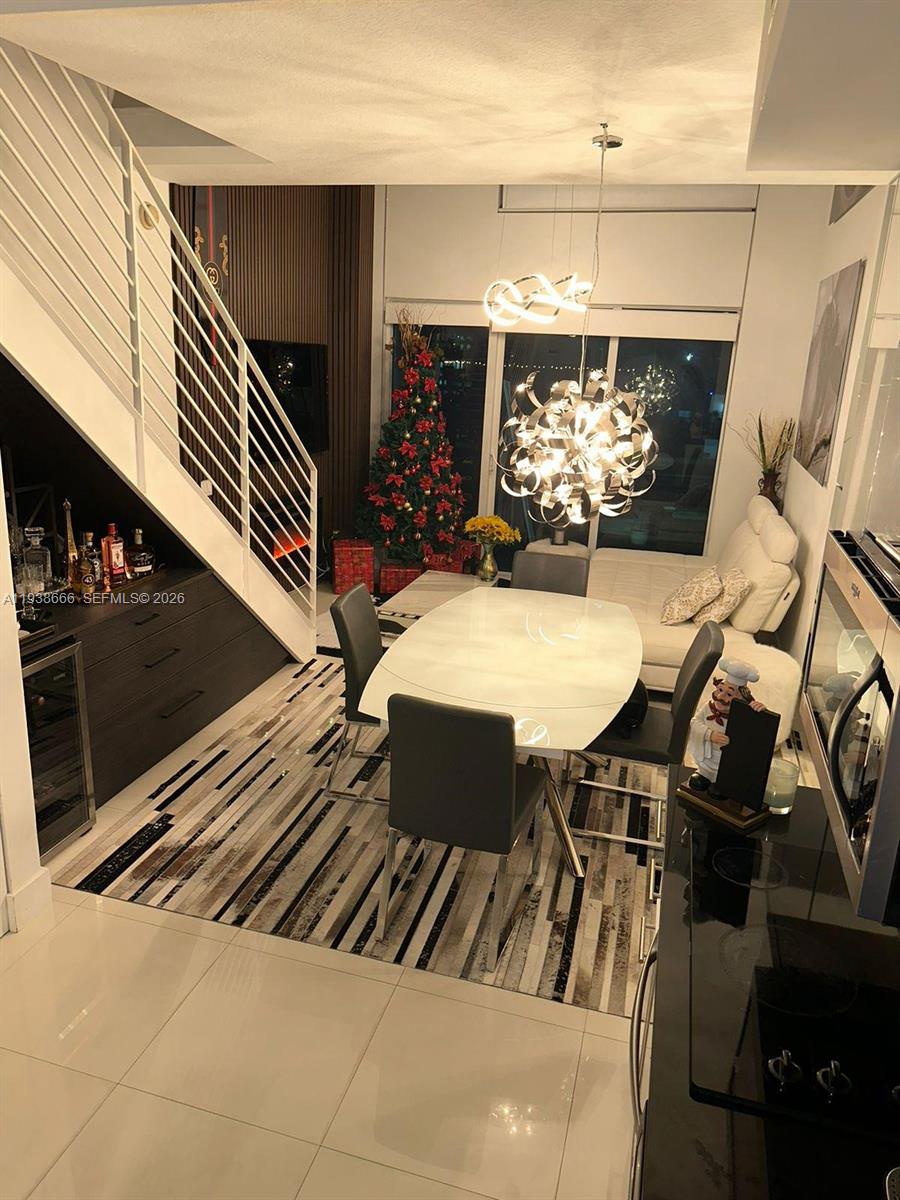 60 Southwest 13th Street, Unit 2422 Miami, FL 33130 - Photo 30 of 33 a view of a dining room with furniture and a chandelier