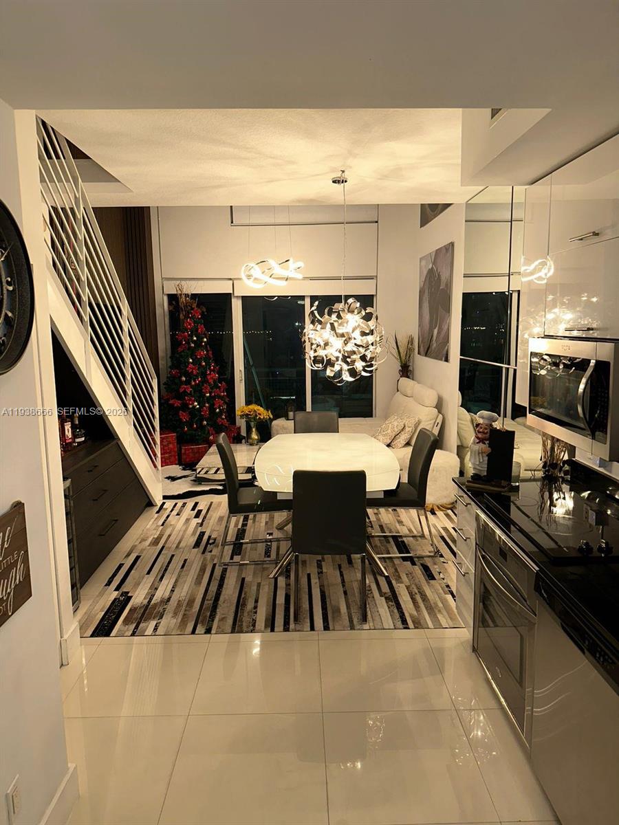 60 Southwest 13th Street, Unit 2422 Miami, FL 33130 - Photo 3 of 33 a living room with furniture a rug and a flat screen tv