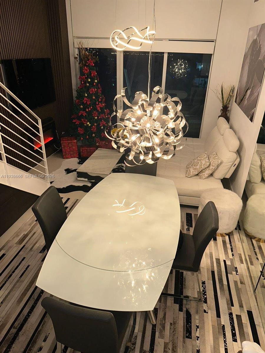 60 Southwest 13th Street, Unit 2422 Miami, FL 33130 - Photo 33 of 33 a view of a dining room with furniture and chandelier
