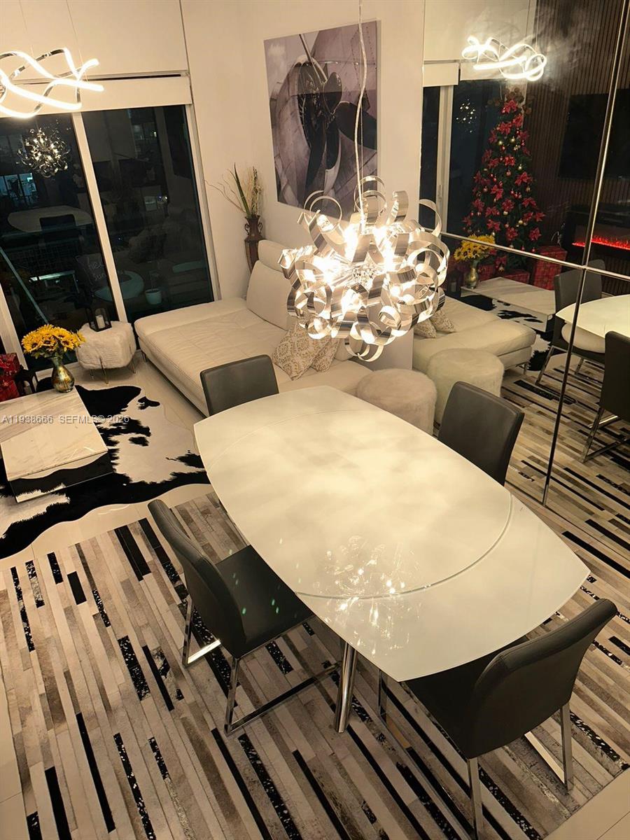 60 Southwest 13th Street, Unit 2422 Miami, FL 33130 - Photo 4 of 33 a view of a balcony dining table and chairs