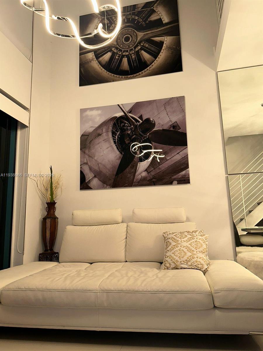 60 Southwest 13th Street, Unit 2422 Miami, FL 33130 - Photo 10 of 33 a living room with a couch and a stove