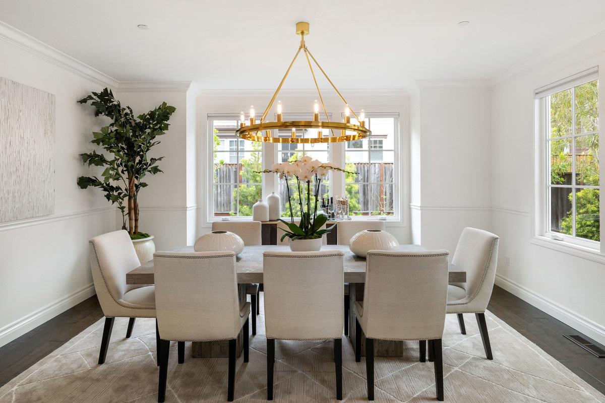 116 Carnoustie Drive Half Moon Bay, CA 94019 - Photo 5 of 27 a dining room with furniture a chandelier and wooden floor