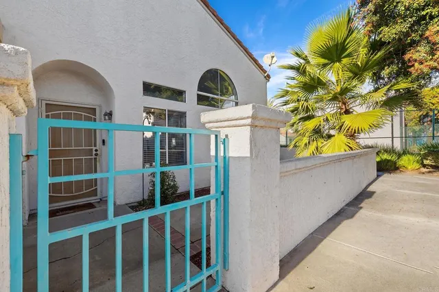 a view of a brick house with a large windows and a large tree