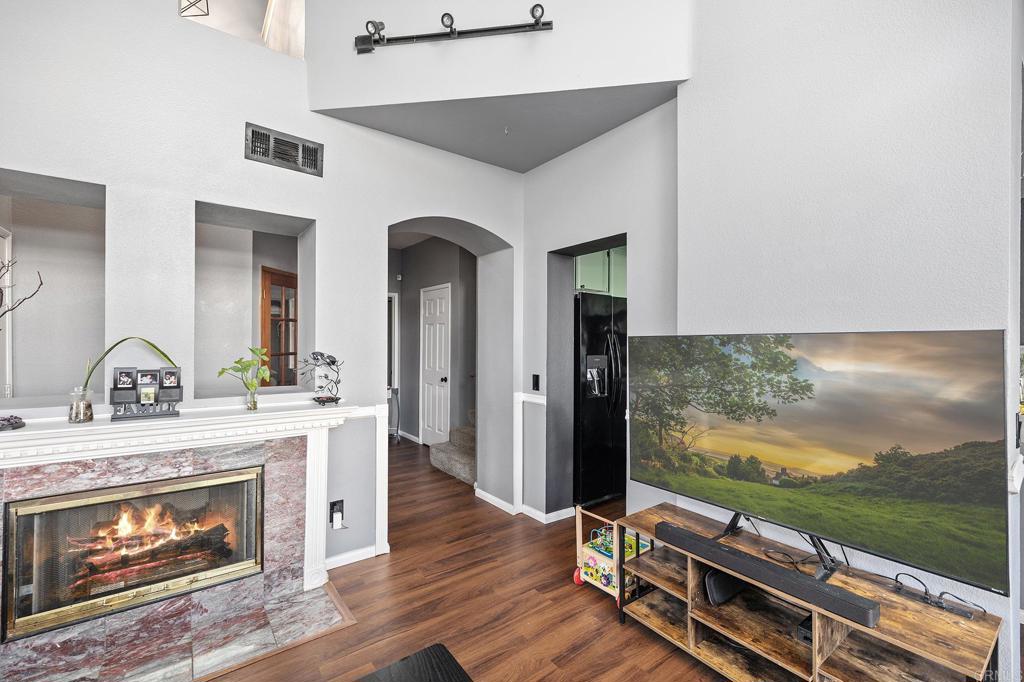 29495 Cara Way Temecula, CA 92591 - Photo 18 of 40 a living room with fireplace furniture and a flat screen tv