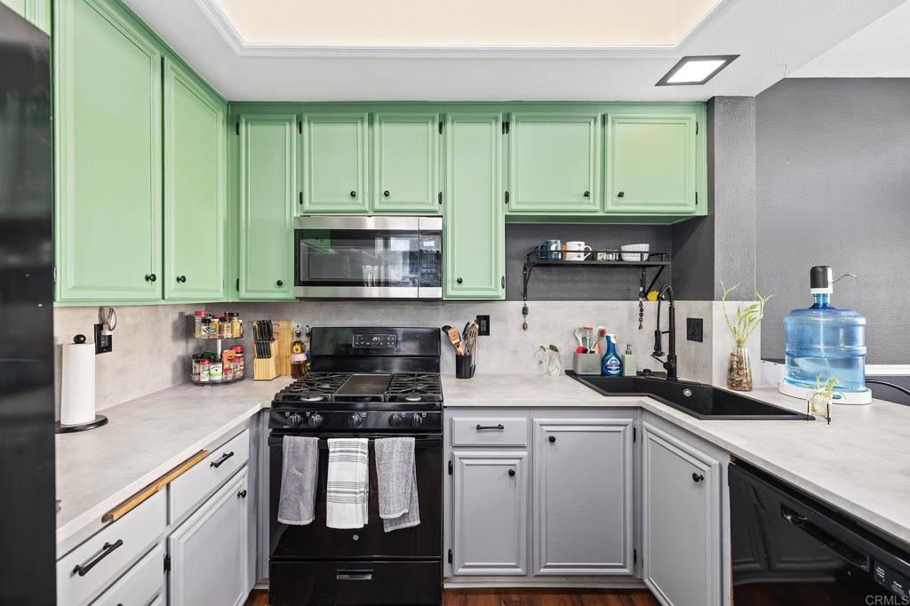 29495 Cara Way Temecula, CA 92591 - Photo 20 of 40 a kitchen with white cabinets and a stove