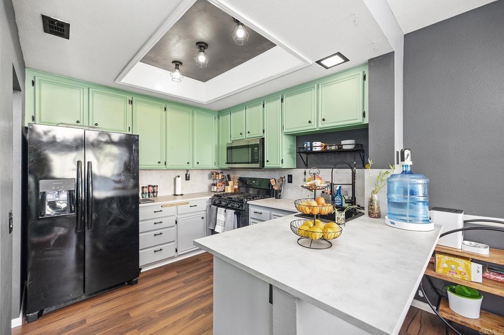 29495 Cara Way Temecula, CA 92591 - Photo 2 of 40 a kitchen with stainless steel appliances granite countertop a refrigerator a stove top oven a sink dishwasher and a refrigerator