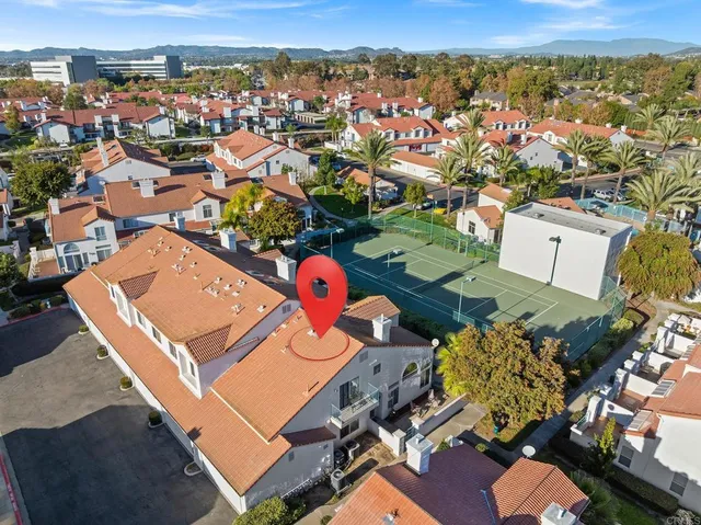 an aerial view of a houses with a swimming pool