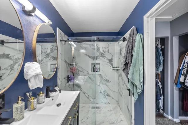 a bathroom with a sink vanity and a mirror