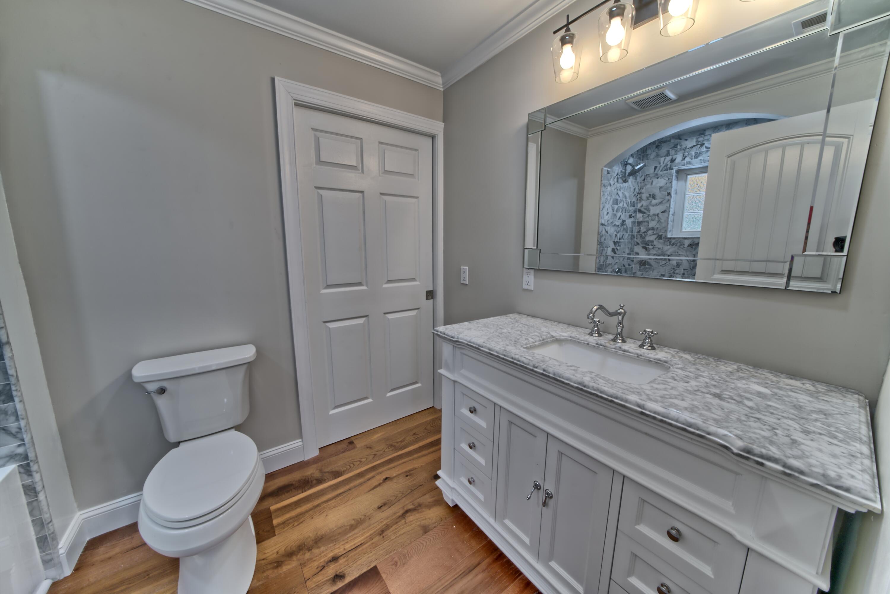 521 Clareon Drive Inlet Beach, FL 32461 - Photo 16 of 66 a bathroom with a granite countertop toilet sink and mirror