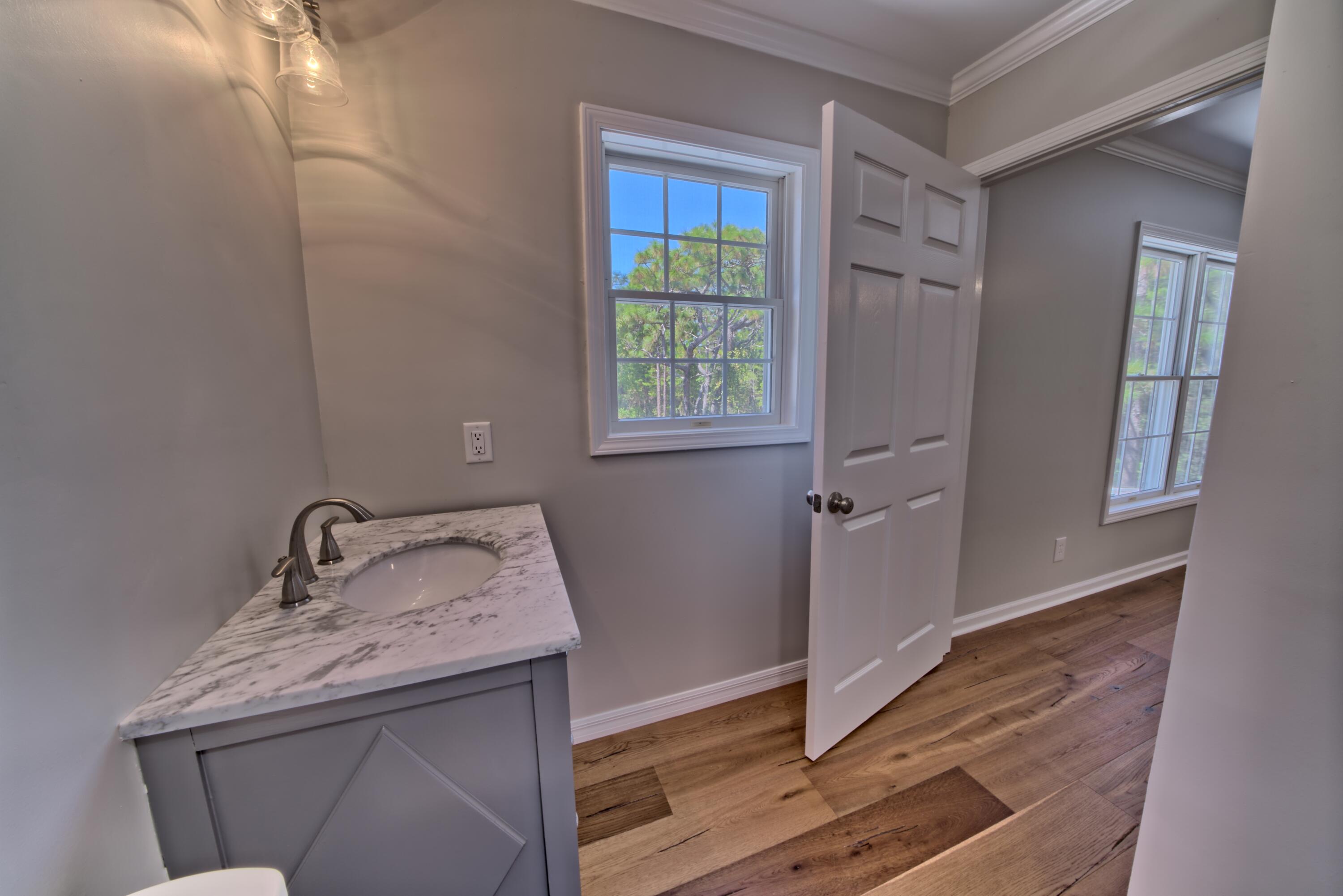 521 Clareon Drive Inlet Beach, FL 32461 - Photo 28 of 66 a bathroom with a sink and mirror