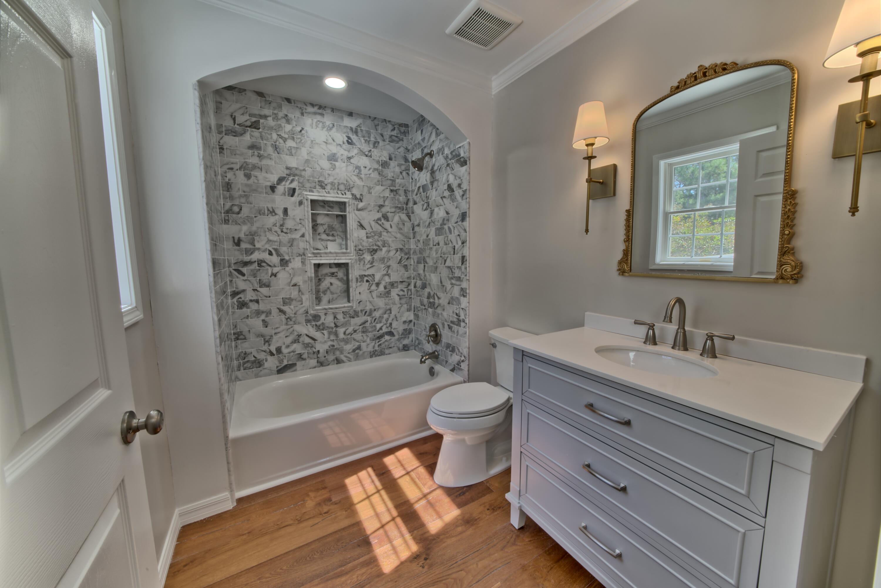 521 Clareon Drive Inlet Beach, FL 32461 - Photo 29 of 66 a bathroom with a double vanity sink toilet mirror and bathtub