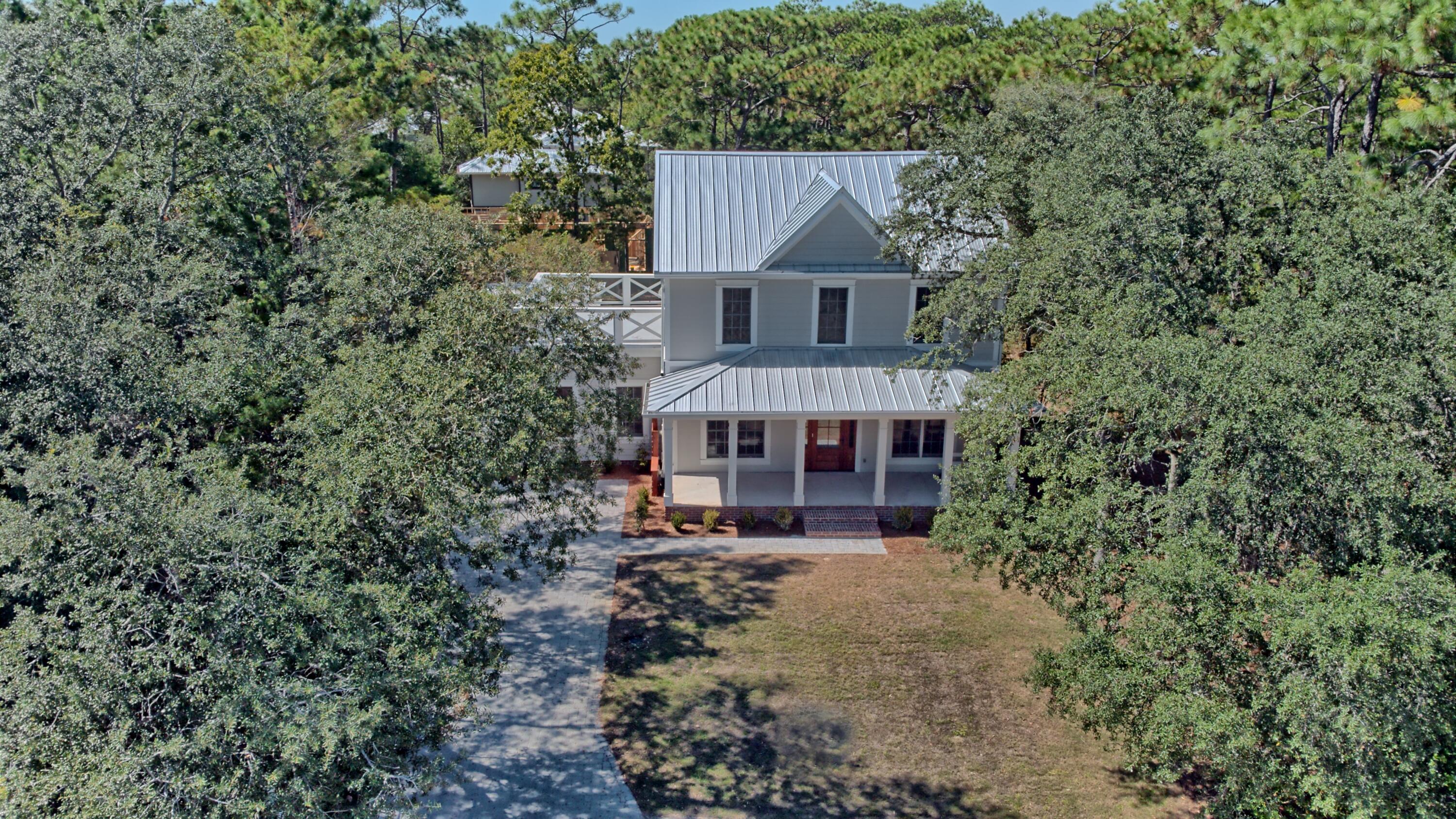 521 Clareon Drive Inlet Beach, FL 32461 - Photo 40 of 66 a front view of a house with yard and trees