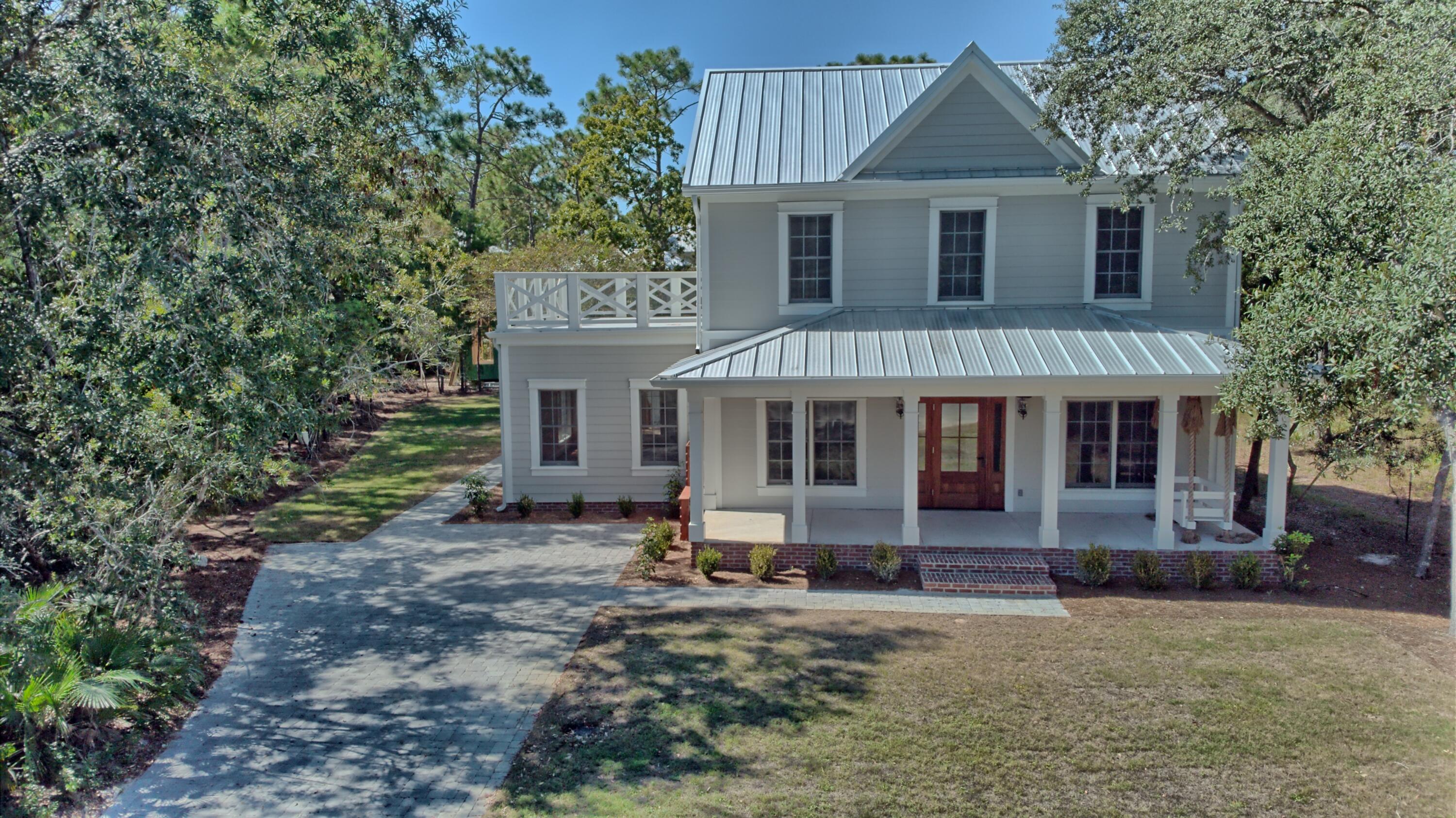 521 Clareon Drive Inlet Beach, FL 32461 - Photo 43 of 66 a front view of a house with garden