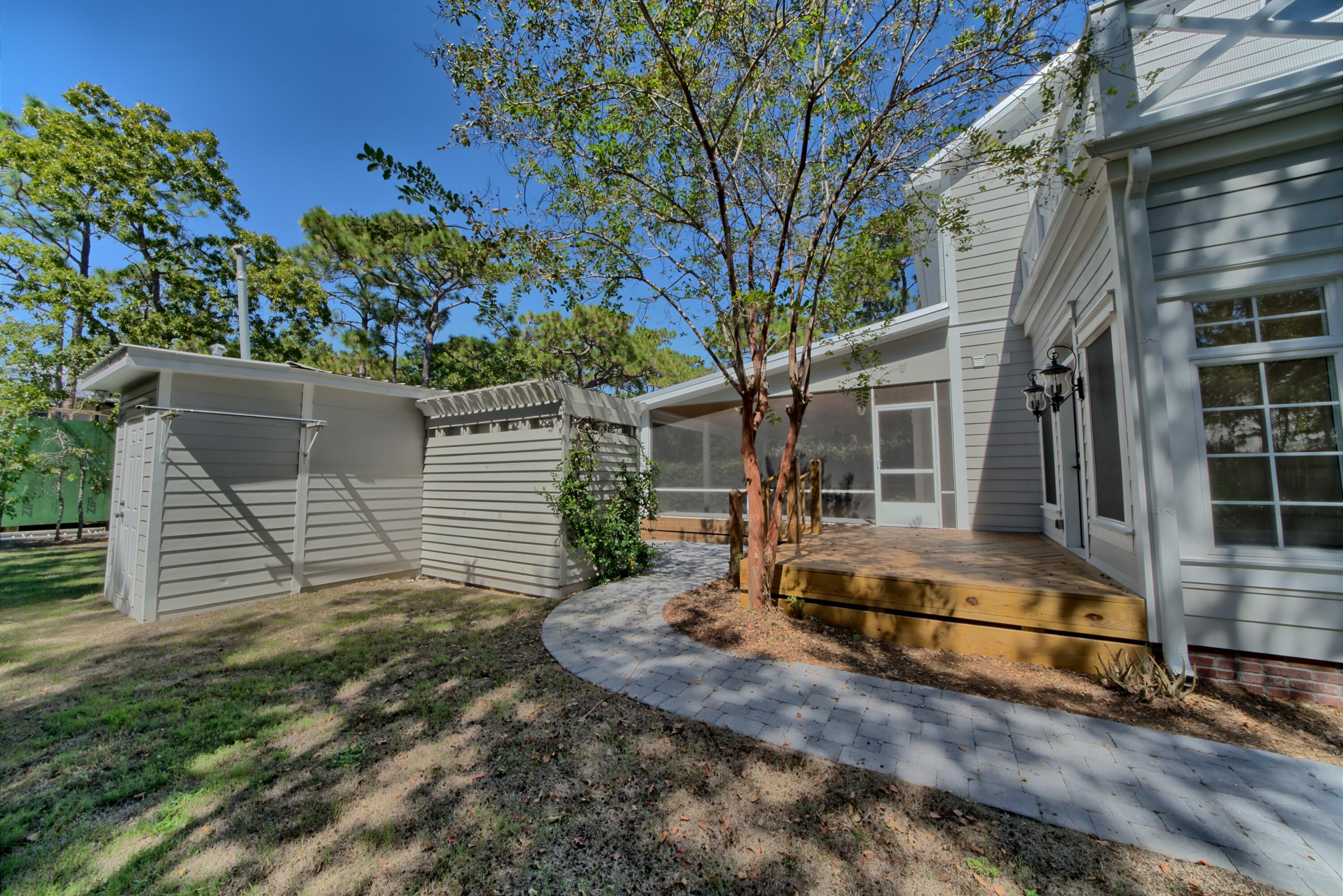 521 Clareon Drive Inlet Beach, FL 32461 - Photo 55 of 66 a view of a house with a yard and large tree