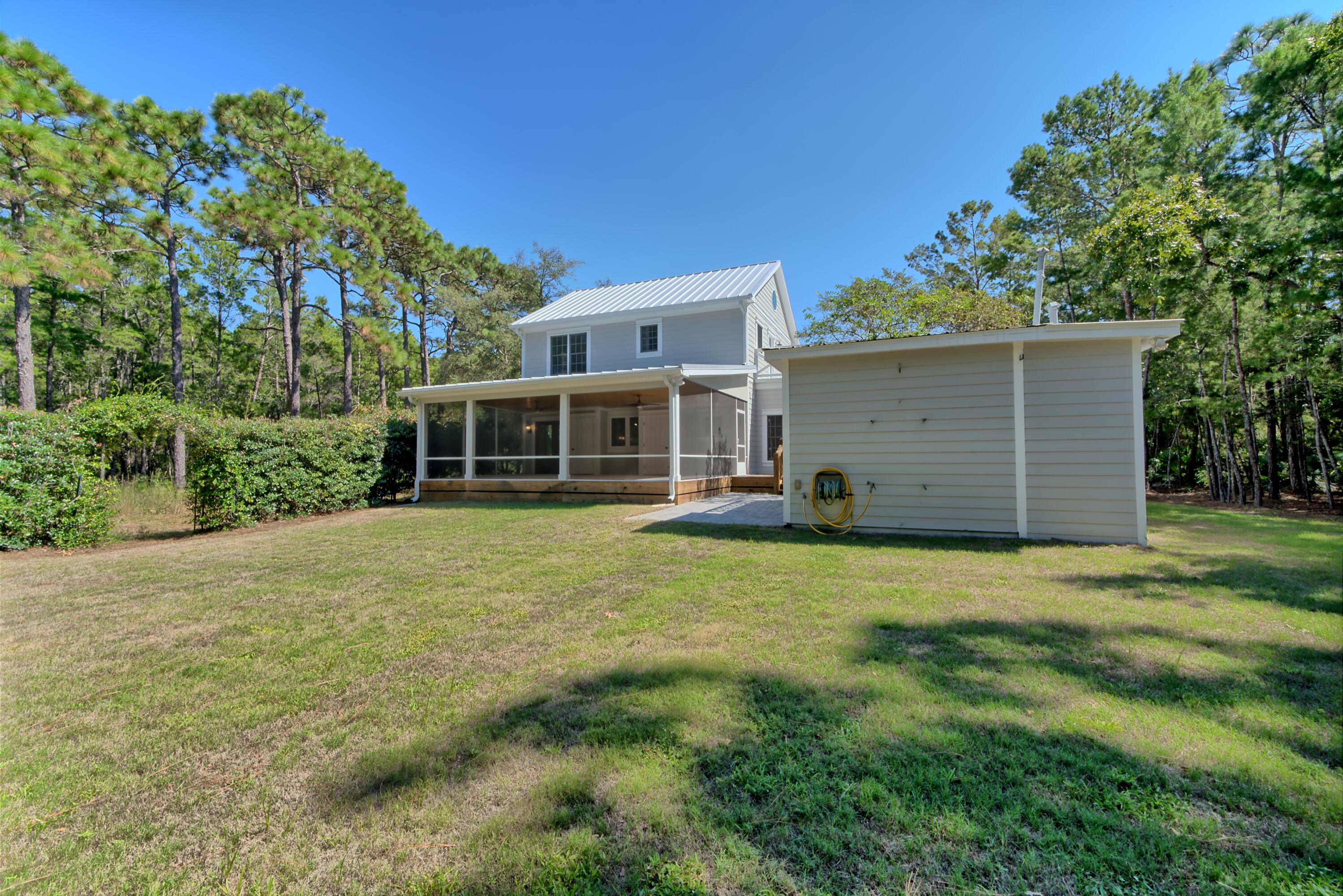 521 Clareon Drive Inlet Beach, FL 32461 - Photo 57 of 66 a front view of a house with a garden