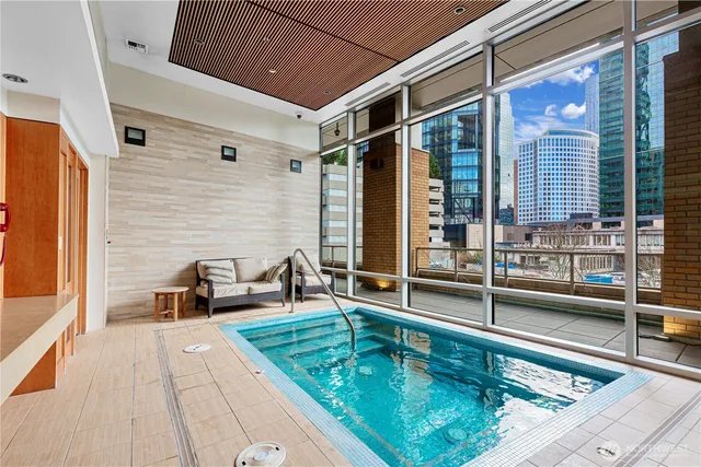 a swimming pool with outdoor seating