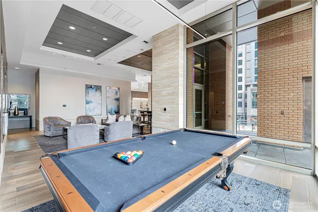 a room with furniture pool table and wooden floor