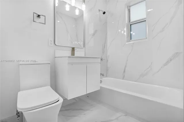 a bathroom with a toilet and a bathtub