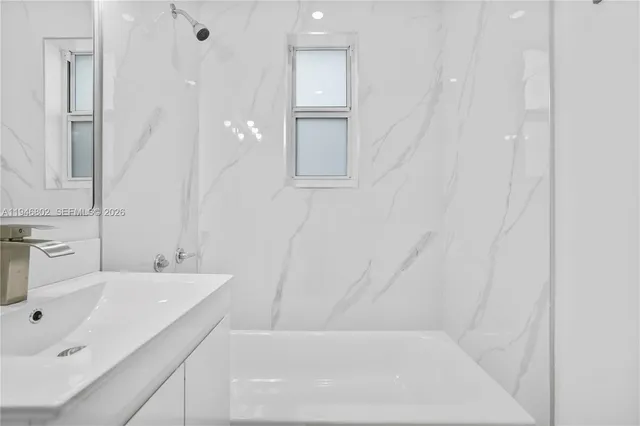 a bathroom with a bathtub and a sink