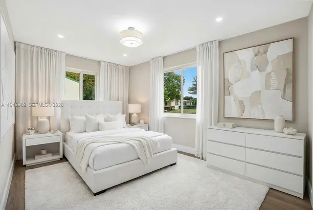 a bedroom with a large bed and a large window