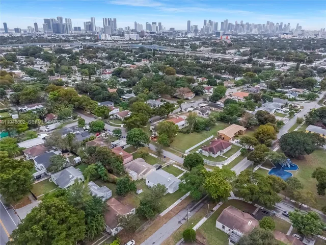 an aerial view of residential houses with city view