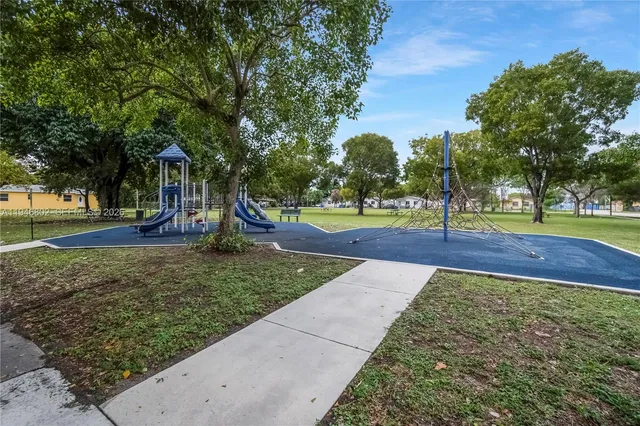a view of a park with swings and slides