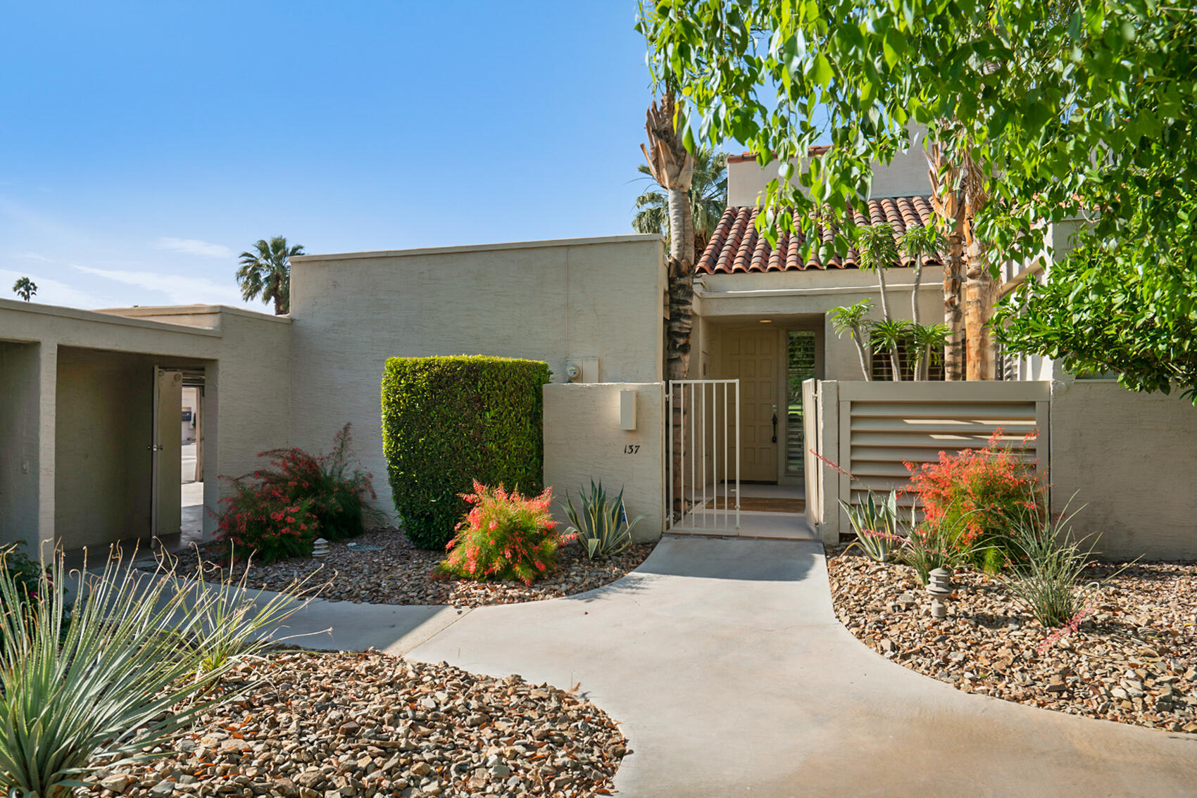 137 Desert W Drive Rancho Mirage, CA 92270 - Photo 1 of 56 a front view of a house