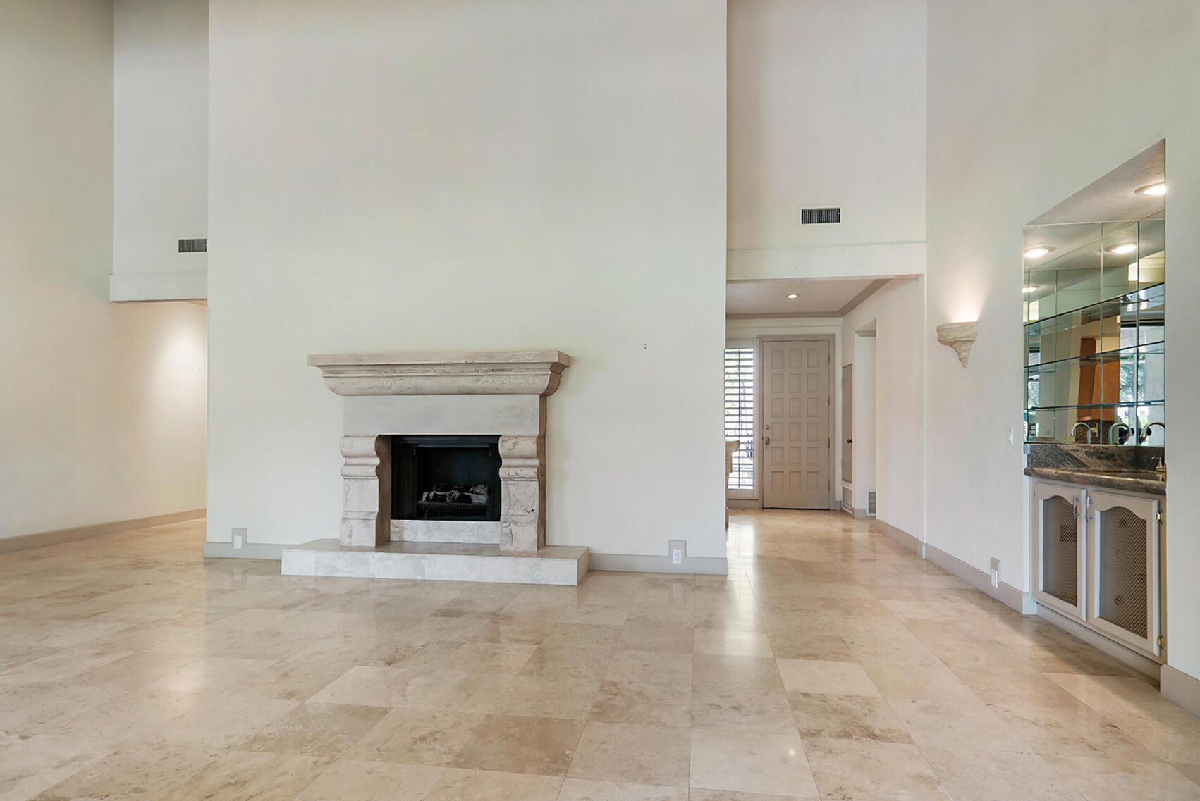 137 Desert W Drive Rancho Mirage, CA 92270 - Photo 11 of 56 an empty room with a fireplace and window