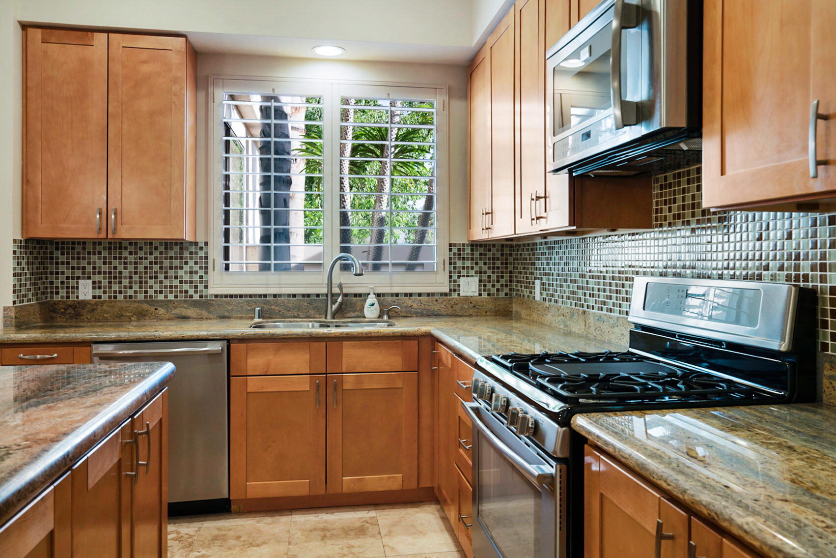 137 Desert W Drive Rancho Mirage, CA 92270 - Photo 18 of 56 a kitchen with a sink stove top oven and cabinets