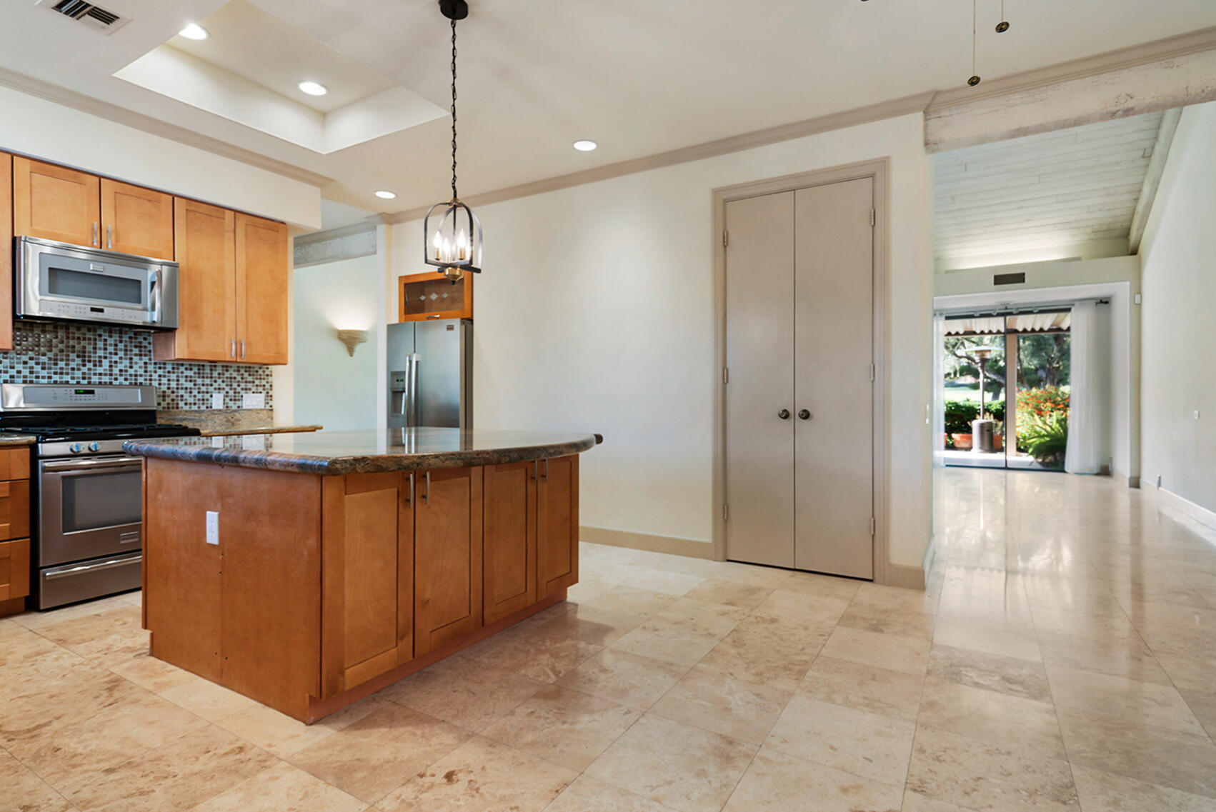 137 Desert W Drive Rancho Mirage, CA 92270 - Photo 19 of 56 a kitchen with stainless steel appliances granite countertop a stove a sink and a refrigerator