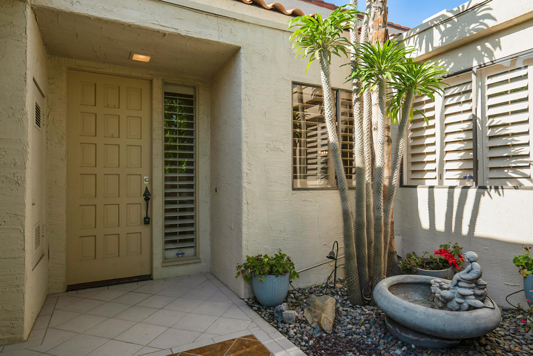 137 Desert W Drive Rancho Mirage, CA 92270 - Photo 2 of 56 a view of a potted plants in front of a door