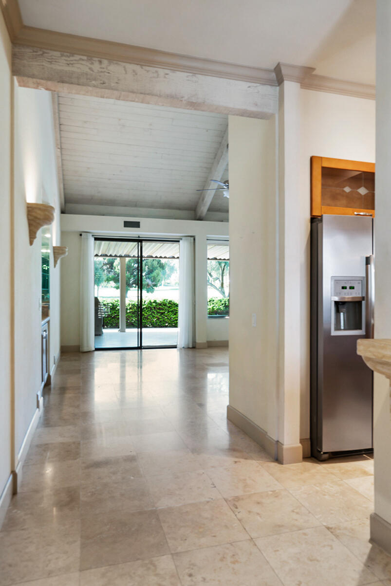 137 Desert W Drive Rancho Mirage, CA 92270 - Photo 3 of 56 a view of a hallway with wooden floor and a living room